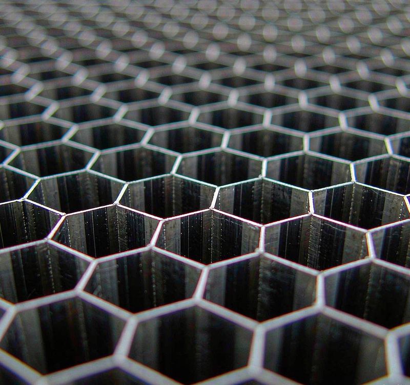 Close up of hexagonal aluminum honeycomb cells showing clean thin walls