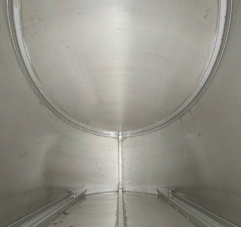 Interior welded seams of an aluminum road tanker shell